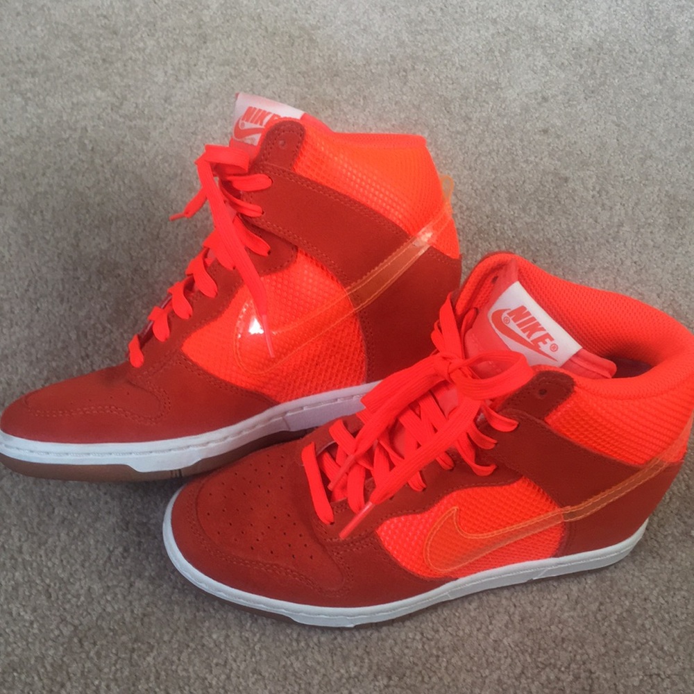 Bright orange Nike shoes with clear swoosh